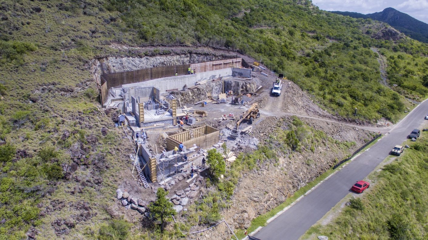 The Cardinal Point house—shown at the top of our post is currently under construction. Upon its completion in November of 2018, the island home will sit nestled in its mountainside location overlooking a protected reef and cove.